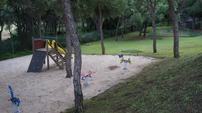 a playground with children playing in the sand at Apartment Calcada in Albufeira