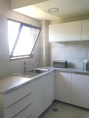 a small kitchen with a sink and a window at Casa Marina in Vilamoura