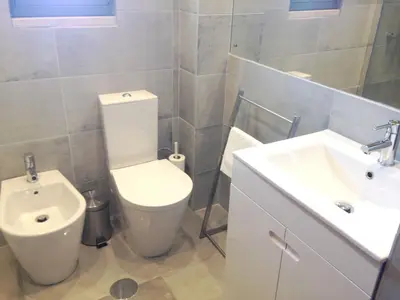a bathroom with a toilet and a sink at Casa Marina in Vilamoura