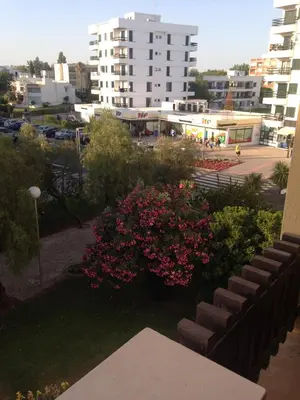 a view of a city from a balcony with pink flowers at Casa Marina in Vilamoura