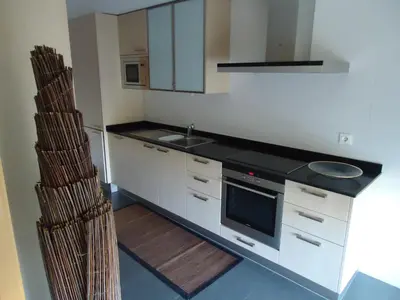 a kitchen with a sink and a stove top oven at Marina Vilamoura Apartment in Vilamoura