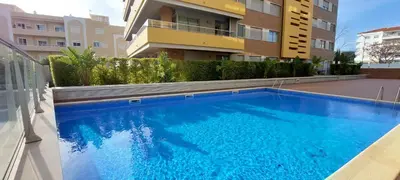 a swimming pool in front of a building at Varandas de Carteia in Quarteira
