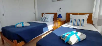 two beds sitting next to each other in a bedroom at Varandas de Carteia in Quarteira