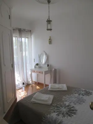 a bedroom with a bed with two towels on it at Casa Vila Verde in Quarteira