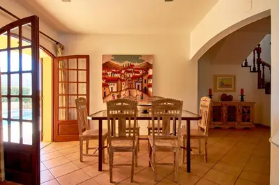 a dining room with a table and chairs at Charming House Vilamoura in Vilamoura