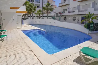 a swimming pool in the middle of a building at Oura Lancemar by Sunny Deluxe in Albufeira