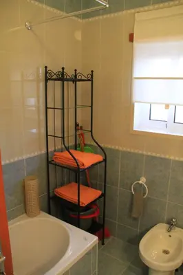 a bathroom with a tub and a toilet and a sink at MSHomes Corcovada in Albufeira