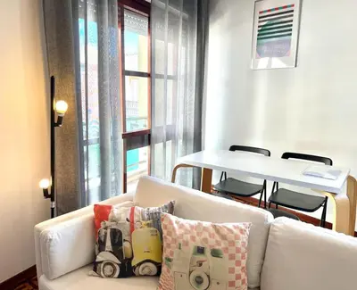 a living room with a white couch and a table at Casa Marum in Faro