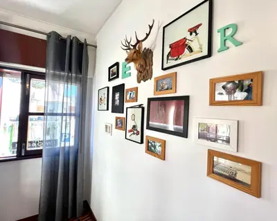 a wall with pictures on it with a window at Casa Marum in Faro