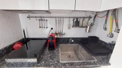 a kitchen with a sink and a counter top at Sailing Studio Açoteias in Albufeira