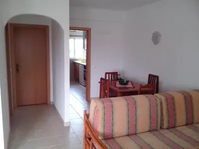 a living room with a couch and a table at Apartment with 1 Bedroom D in Albufeira