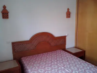 a bedroom with a bed with a wooden head board at Apartment with 1 Bedroom L in Albufeira
