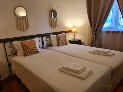 a bedroom with two beds with towels on them at Aldeia do Golf - Vila I8 in Vilamoura
