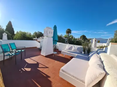 a patio with a couch and chairs on a roof at Aldeia do Golf - Vila I8 in Vilamoura