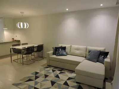 a living room with a couch and a table at Sao Rafael - Apartamento Studio in Albufeira