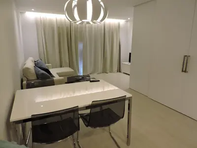 a living room with a white table and chairs at Sao Rafael - Apartamento Studio in Albufeira
