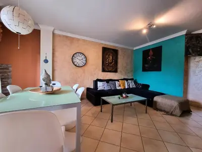 a living room with a couch and a table at T1 Falesia in Albufeira