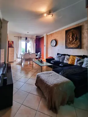 a living room with a bed and a table at T1 Falesia in Albufeira