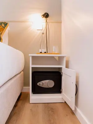 a bed room with a microwave in a cabinet next to a bed at Dear Faro - Guest House in Faro