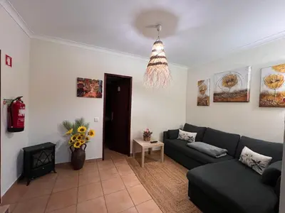 a living room with a couch and a table at Quinta dos Viegas in Faro