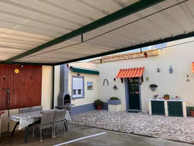 a patio with a table and chairs and a building at Quinta dos Viegas in Faro