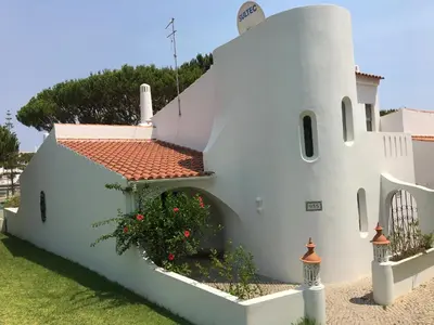 a white house with a staircase and flowers at Vale Do Lobo 935 in Loulé