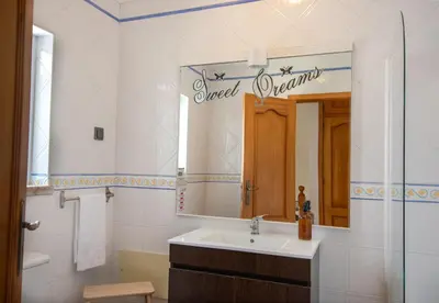 a bathroom with a sink and a mirror at Casa Galé - Joia das Sesmarias 600mts praia in Albufeira