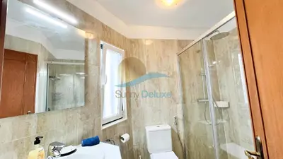 a bathroom with a shower and a toilet and a sink at Villa Golfinho by Sunny Deluxe in Albufeira