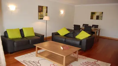 a living room with two couches and a coffee table at Apartamento Corcovada - By Bedzy in Albufeira