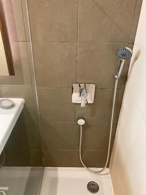 a bathroom with a shower with a sink and a shower at Urbisol 202-Albufeira in Albufeira