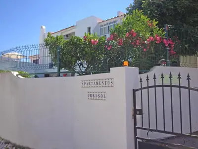 a white fence with a gate with a sign on it at Urbisol 202-Albufeira in Albufeira