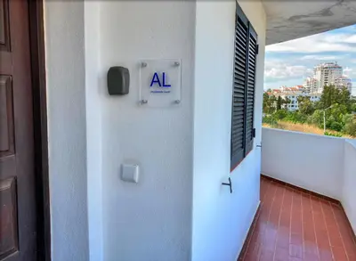 a room with an al sign on a balcony at Urbisol 202-Albufeira in Albufeira