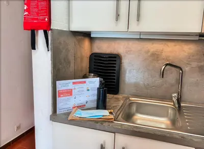 a kitchen counter with a sink and a sign at Urbisol 202-Albufeira in Albufeira