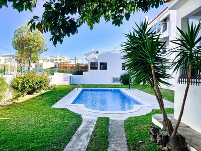 a swimming pool in the backyard of a house at Urbisol 202-Albufeira in Albufeira