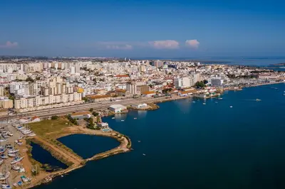 an aerial view of a city with a body of water at Casa das Lontras in Faro