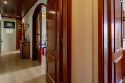 a hallway with wooden doors in a house at Casa das Lontras in Faro
