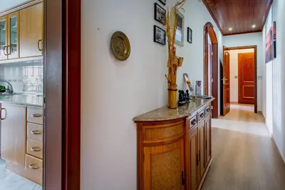a kitchen with wooden cabinets and a counter top at Casa das Lontras in Faro