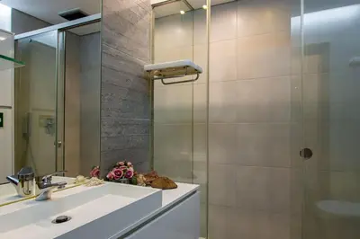 a bathroom with a sink and a shower at Casa das Lontras in Faro