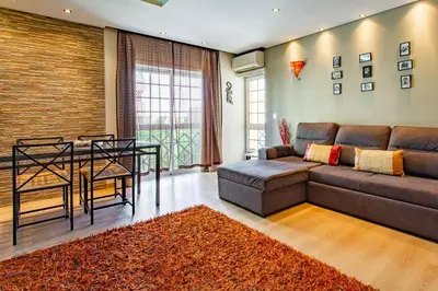 a living room with a couch and a table at Casa das Lontras in Faro