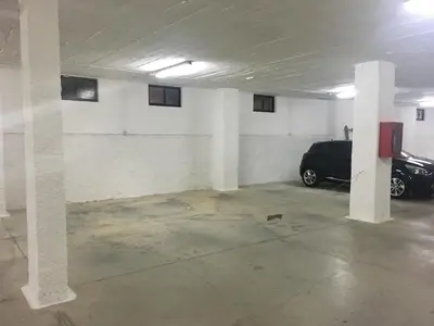 a parking garage with a car parked in it at Olhos Do Mar Albufeira in Albufeira
