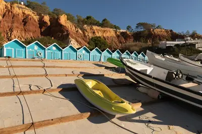 a bunch of boats on a beach with houses at Olhos Do Mar Albufeira in Albufeira