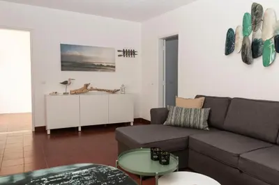 a living room with a couch and a table at Olhos Do Mar Albufeira in Albufeira