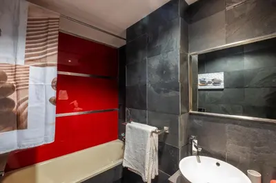 a bathroom with red and black walls and a sink at Funtastic Albufeira Marina 1b3b in Albufeira