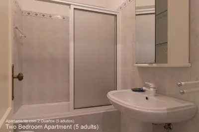 a white bathroom with a sink and a shower at Akisol Vilamoura Pine in Quarteira