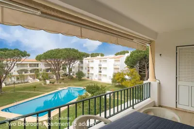 a balcony with a view of a pool at Akisol Vilamoura Pine in Quarteira