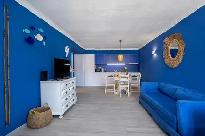 a blue living room with a blue couch and a table at Charming Blue Albufeira in Albufeira