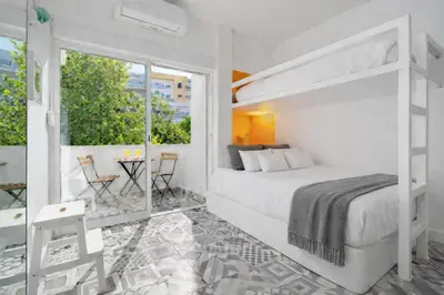 a bedroom with a bunk bed and a balcony at Warm Yellow Albufeira in Albufeira