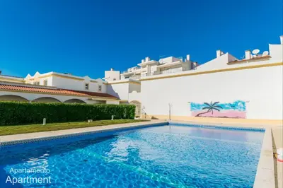 a swimming pool in front of a building at Akisol Albufeira Falesia IV in Albufeira