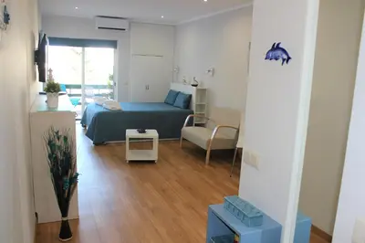 a bedroom with a bed and a living room at Vilamoura Dolphin Studio in Vilamoura