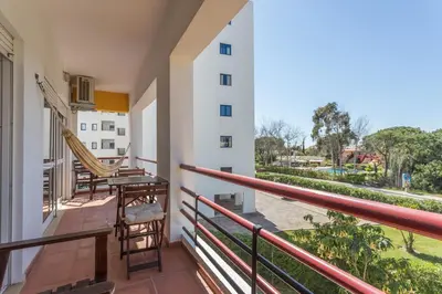 a balcony of a building with a view of the street at FLH Vilamoura Central Flat in Quarteira